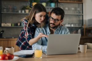 Couple Looking At Laptop Min