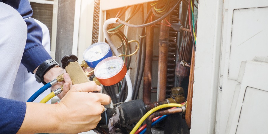 Hvac Tech Performing Maintenance On Unit