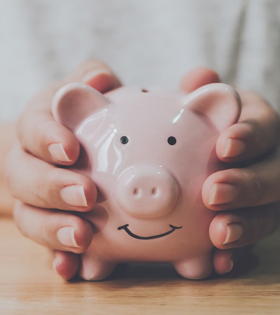 Man Holding Piggy Bank